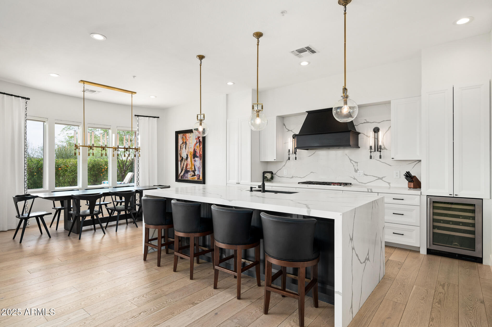 9631 East Mountain Spring Road Scottsdale, AZ 85255 - Photo 13 of 48 a kitchen with stainless steel appliances kitchen island granite countertop a table chairs sink and cabinets