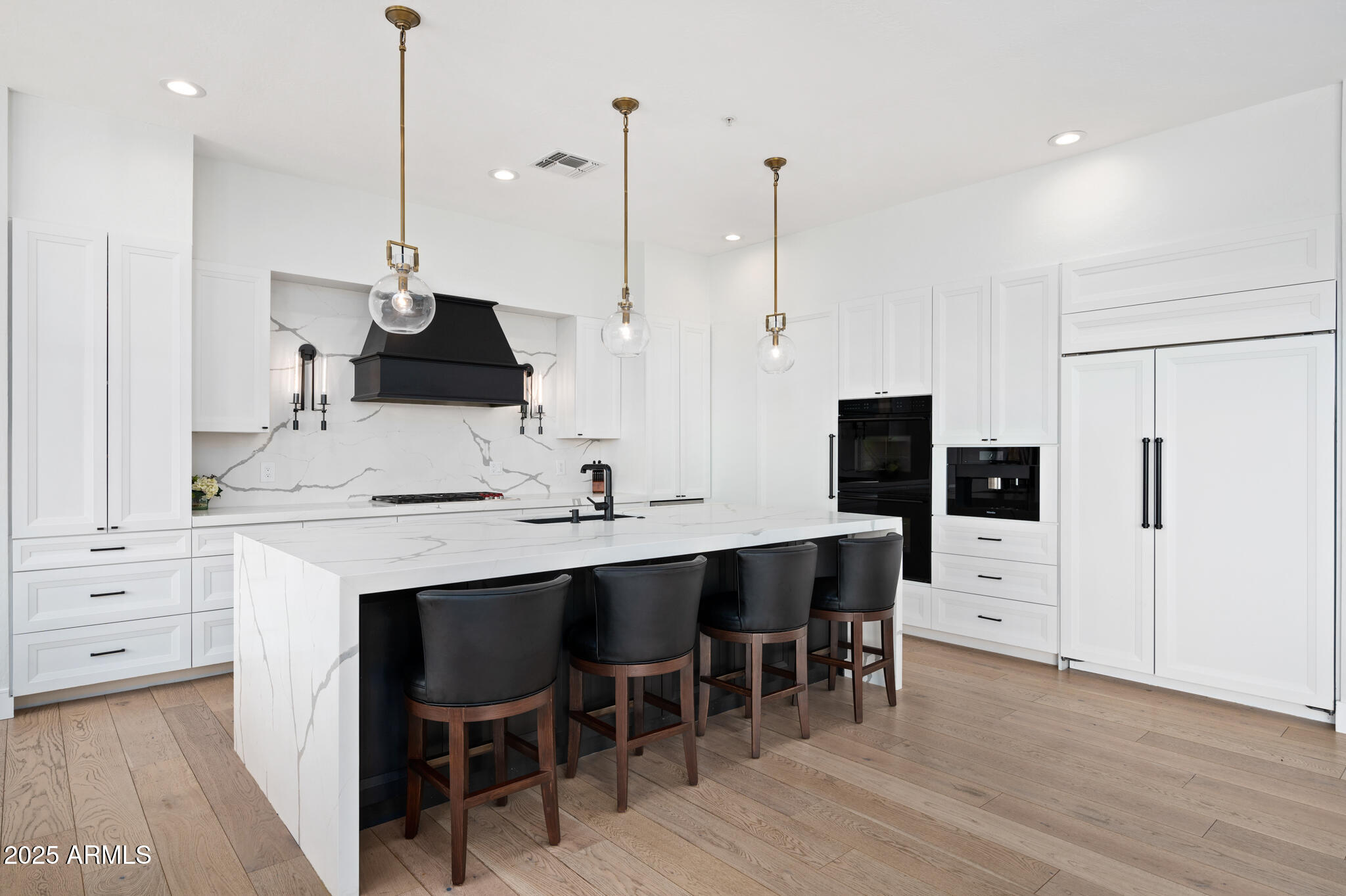 9631 East Mountain Spring Road Scottsdale, AZ 85255 - Photo 15 of 48 a kitchen with stainless steel appliances kitchen island a table and chairs in it