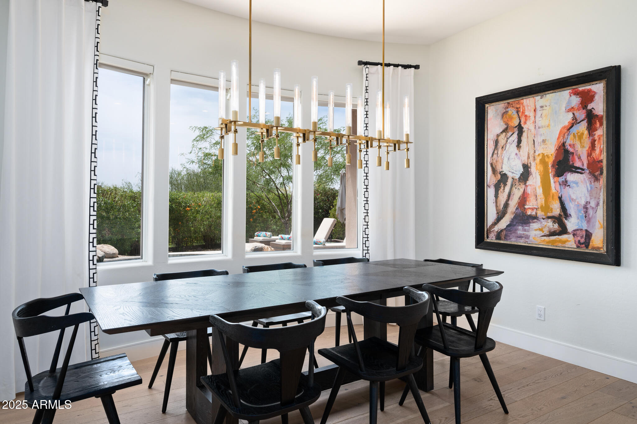 9631 East Mountain Spring Road Scottsdale, AZ 85255 - Photo 20 of 48 a view of a dining room with furniture large windows and wooden floor