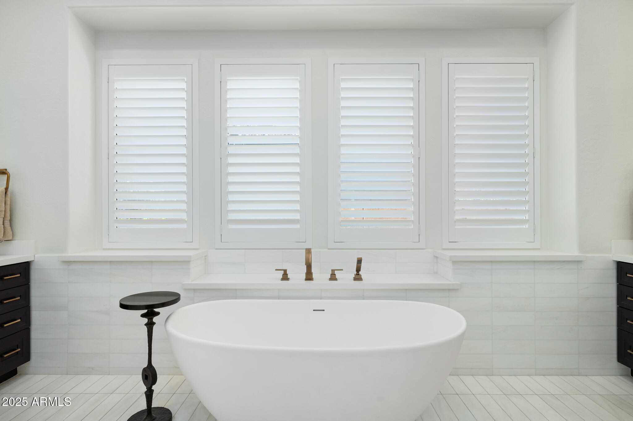 9631 East Mountain Spring Road Scottsdale, AZ 85255 - Photo 25 of 48 a bathroom with a bathtub and a window