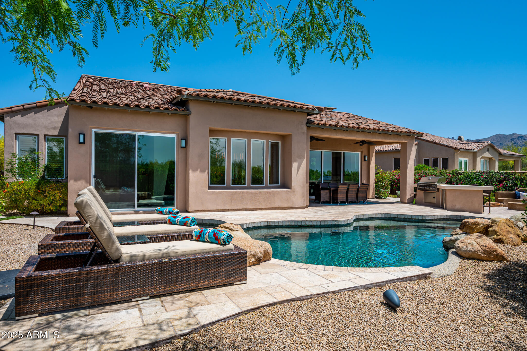 9631 East Mountain Spring Road Scottsdale, AZ 85255 - Photo 38 of 48 a view of a house with swimming pool and a porch