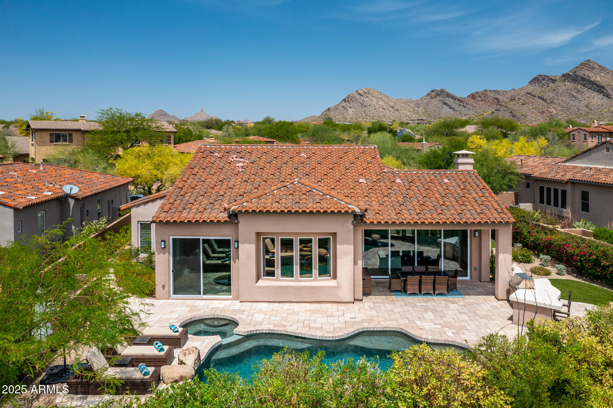 9631 East Mountain Spring Road Scottsdale, AZ 85255 - Photo 44 of 48 a front view of a house with a yard and mountain view