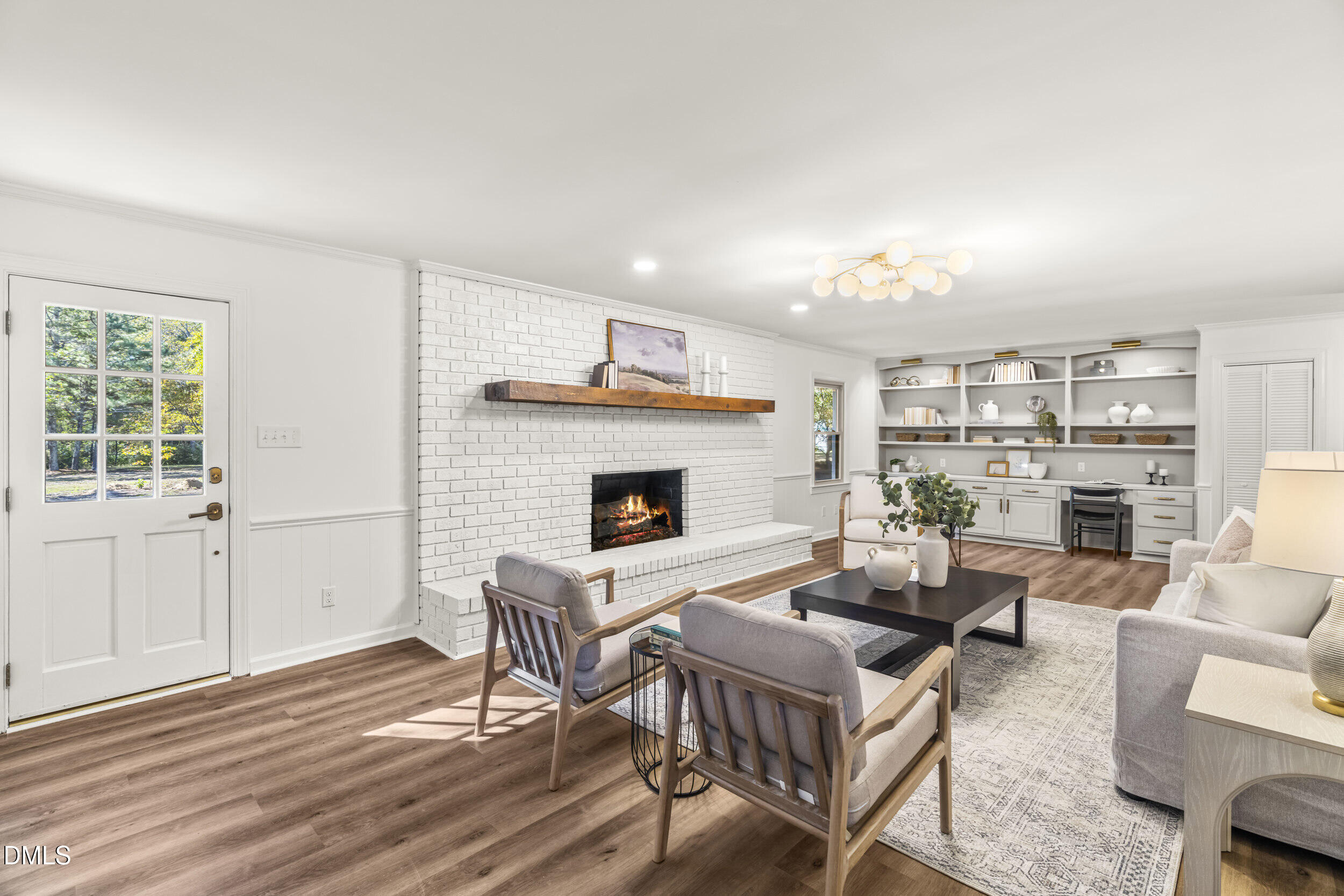 462 Sullivan Road Selma, NC 27576 - Photo 12 of 33 a living room with furniture a fireplace and a table