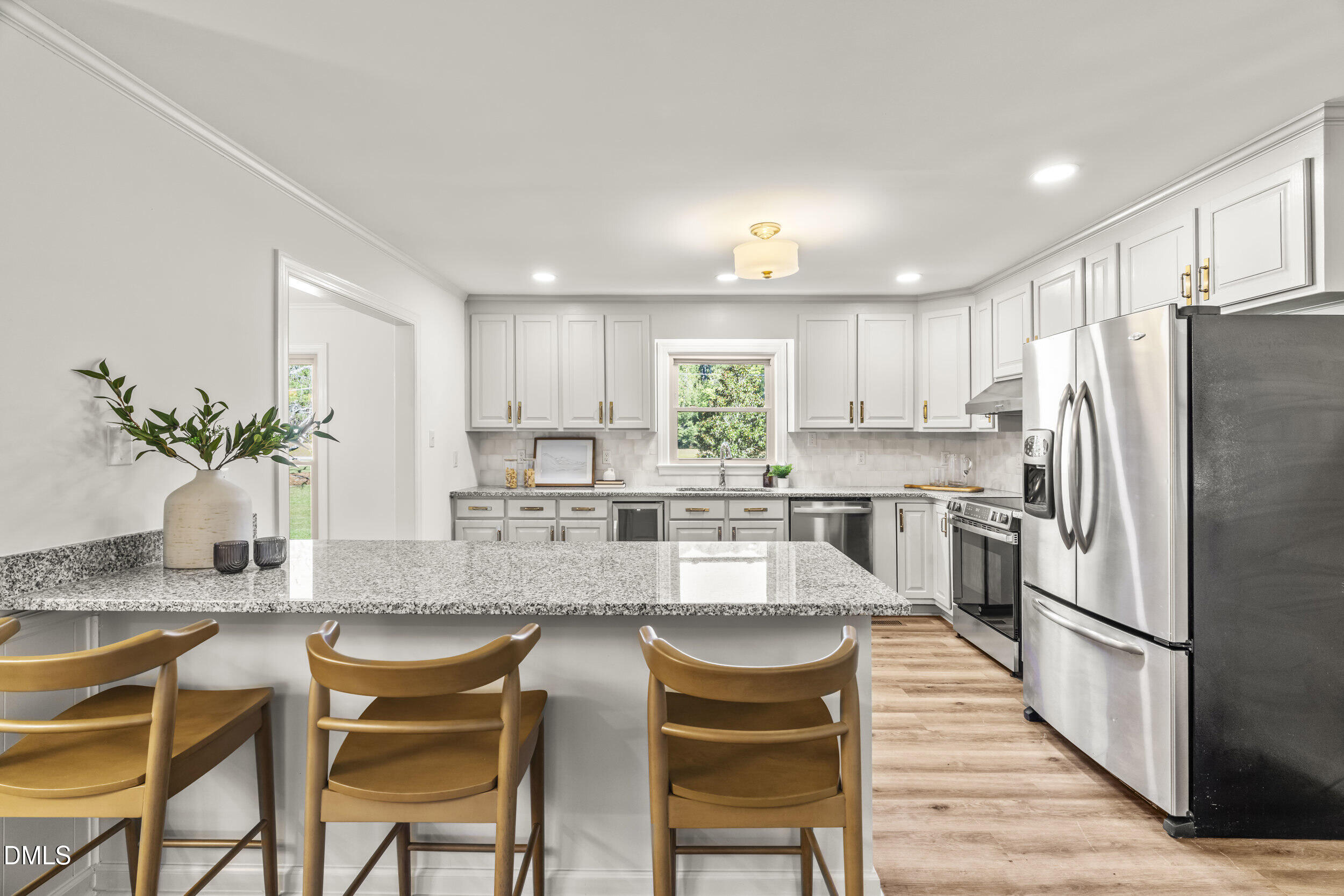 462 Sullivan Road Selma, NC 27576 - Photo 15 of 33 a kitchen with kitchen island granite countertop white cabinets and stainless steel appliances