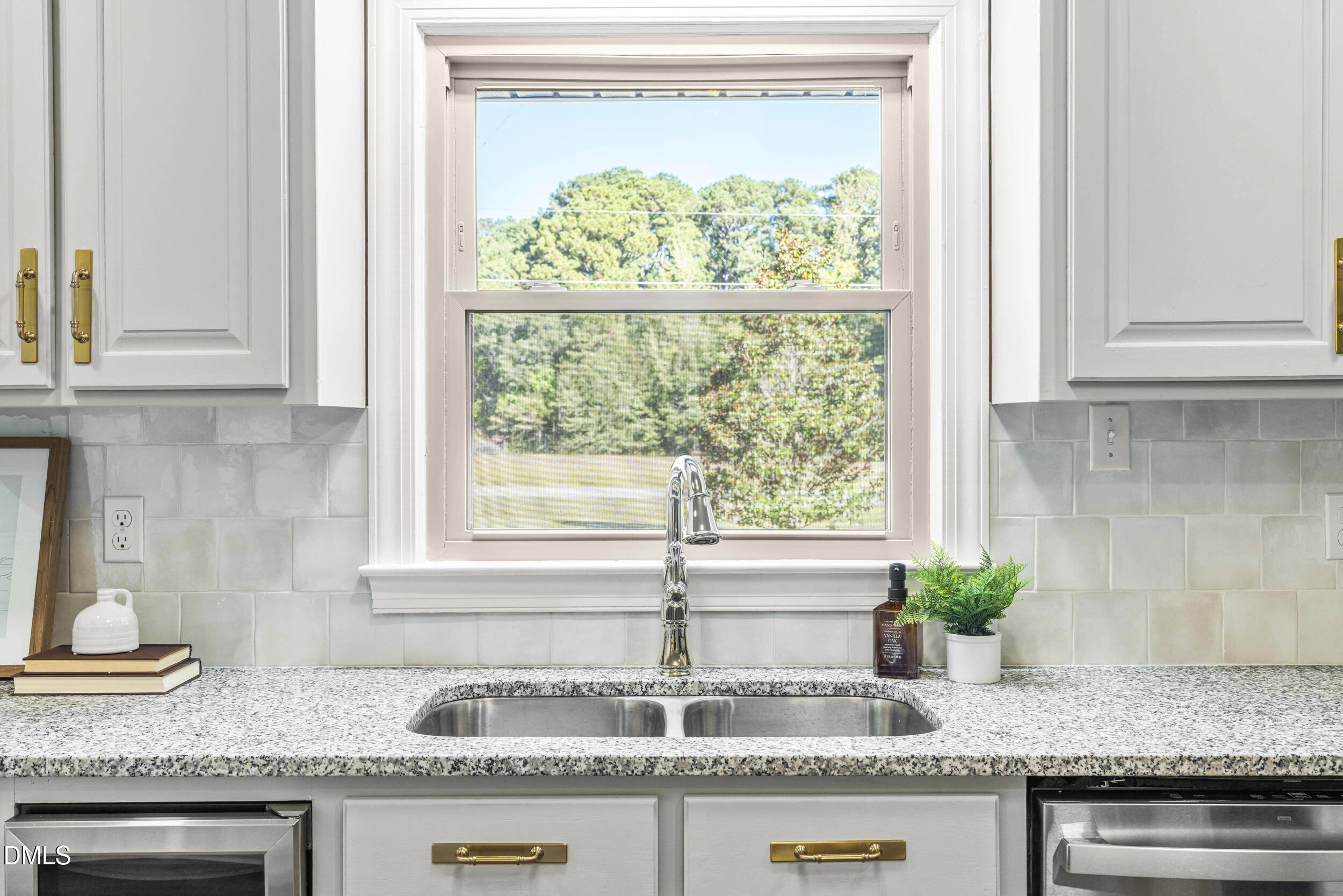 462 Sullivan Road Selma, NC 27576 - Photo 18 of 33 a kitchen with granite countertop a sink and a window