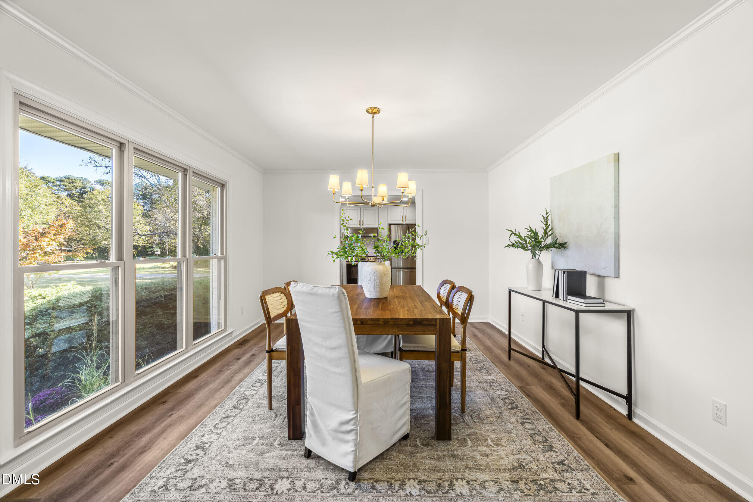 462 Sullivan Road Selma, NC 27576 - Photo 5 of 33 a dining room with furniture a rug and a chandelier