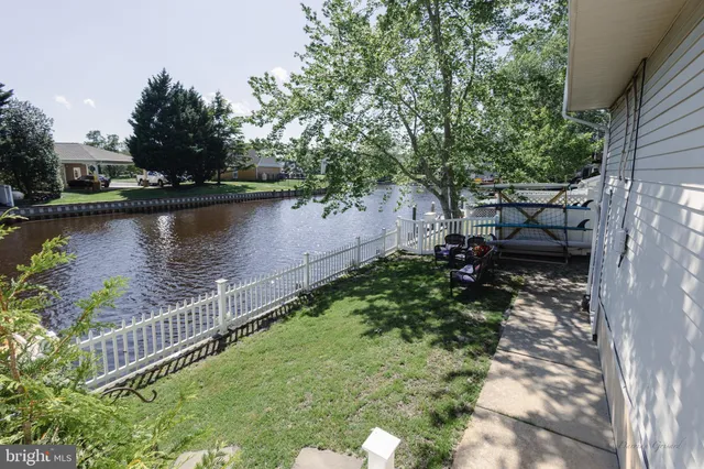 a view of a garden with wooden deck