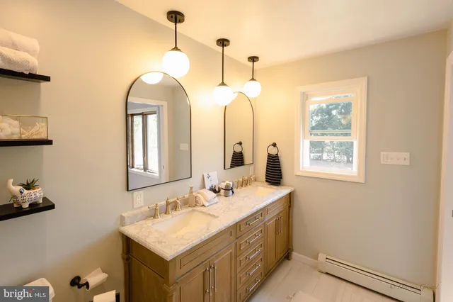 a bathroom with a double vanity sink and a mirror