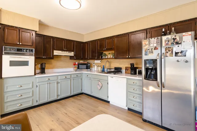 a kitchen with stainless steel appliances granite countertop a refrigerator sink and cabinets