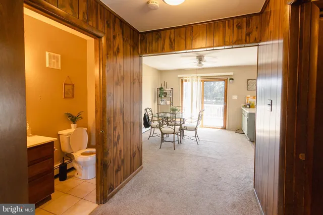 a view of a hallway with living room and utility room