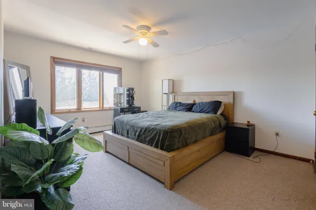 a spacious bedroom with a bed and a chandelier