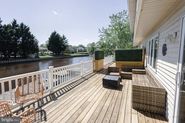 a view of balcony with furniture and lake view