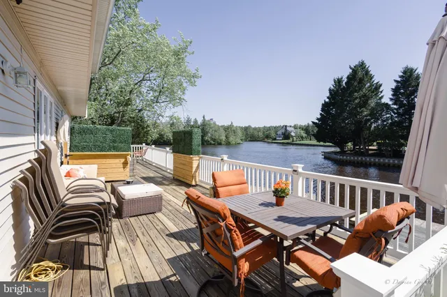 a balcony with wooden floor and outdoor seating