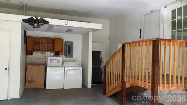 a view of a hallway with entryway and chandelier