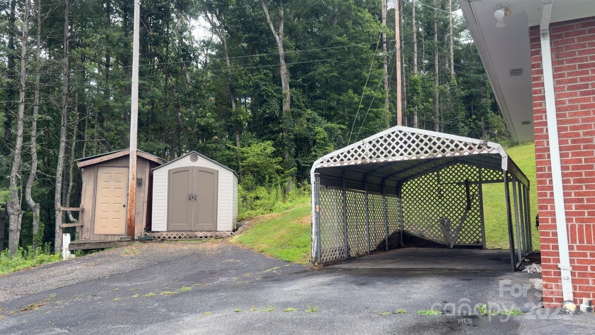 456 Duck Branch Road Bakersville, NC 28705 - Photo 4 of 19 a view of a barn with a small yard and a large parking space