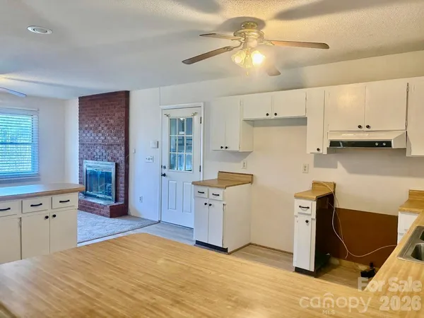 a kitchen with cabinets and wooden floor