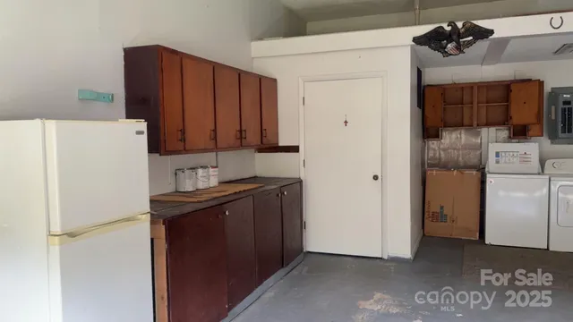 a kitchen with a refrigerator and a stove