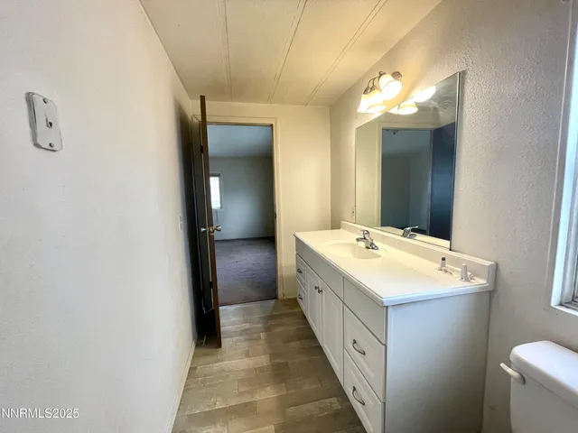 a view of bathroom with a sink and mirror