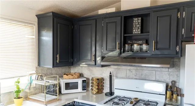 a kitchen with a sink and a stove top oven
