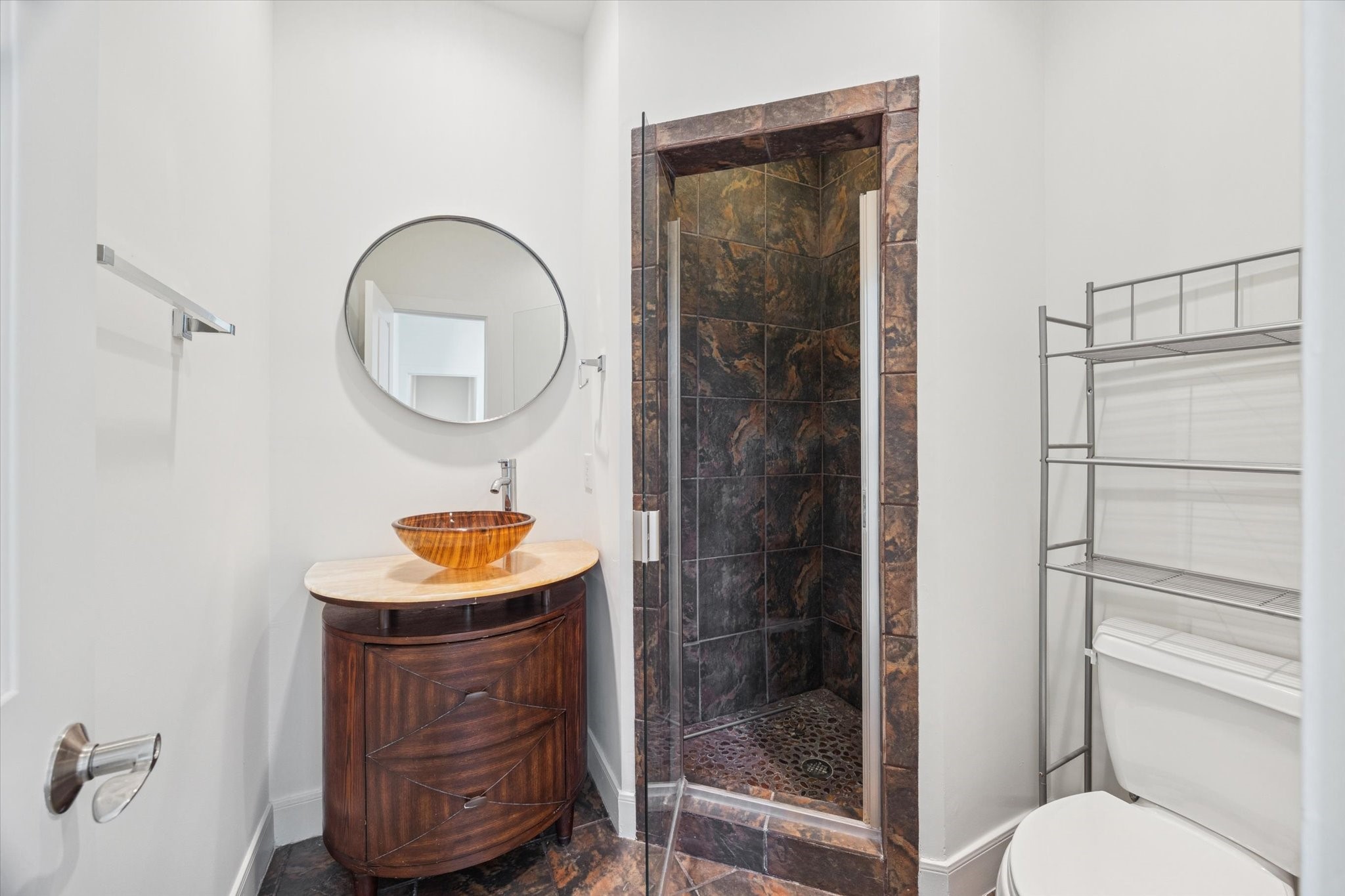 1821 West Main Street, Unit A Houston, TX 77098 - Photo 12 of 12 Stylish first-floor bathroom with walk-in shower, designer tile surround, custom vanity with vessel sink, and modern fixtures.