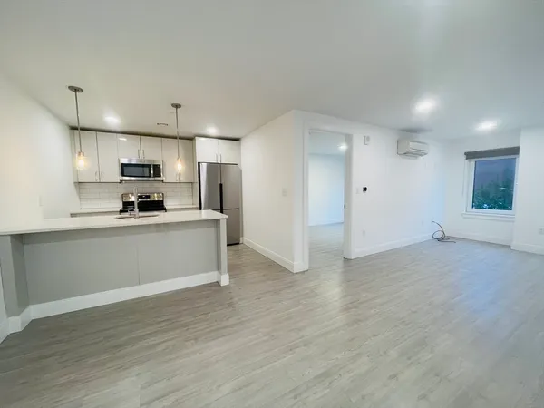 a view of kitchen with refrigerator sink and wooden floor