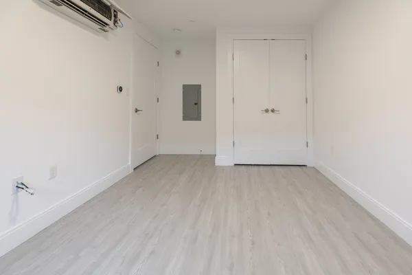 an empty room with wooden floor