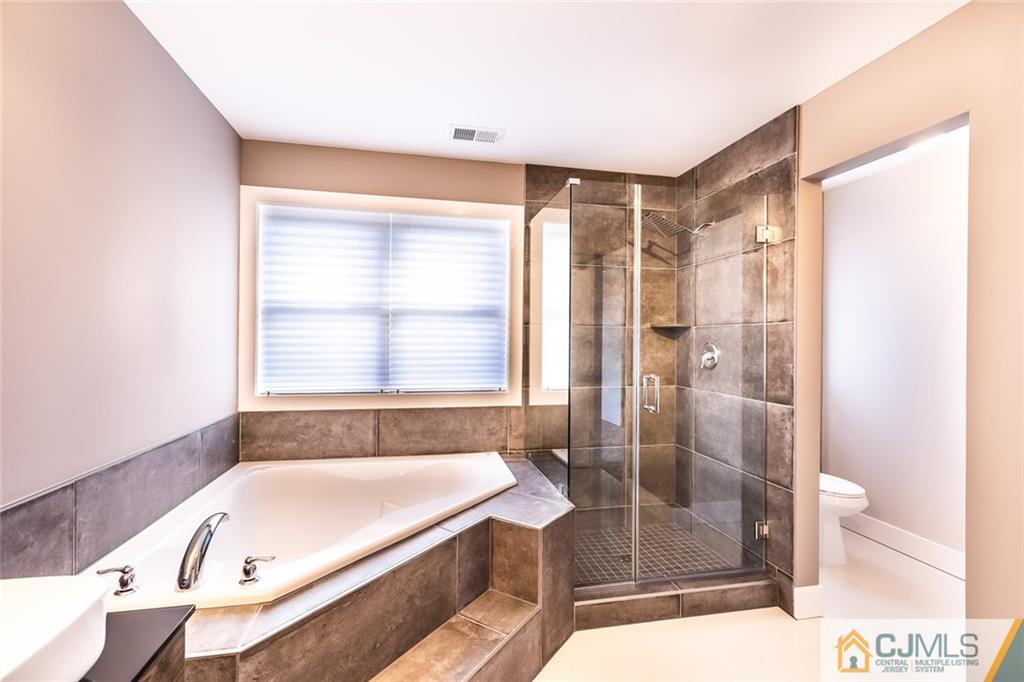 123 Millhurst Road Manalapan, NJ 07726 - Photo 15 of 27 a bathroom with a tub shower and sink