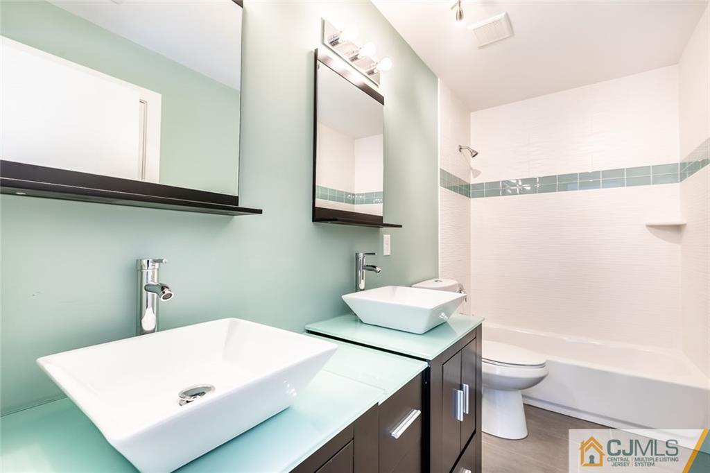 123 Millhurst Road Manalapan, NJ 07726 - Photo 19 of 27 a bathroom with a sink a toilet and a mirror