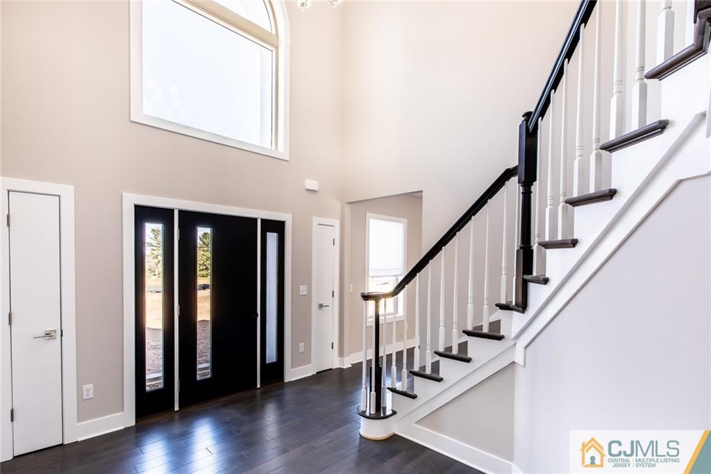 123 Millhurst Road Manalapan, NJ 07726 - Photo 3 of 27 a view of an entryway with wooden floor and stairs