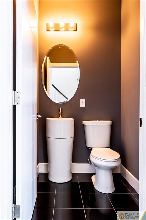 123 Millhurst Road Manalapan, NJ 07726 - Photo 21 of 27 a bathroom with a toilet and a mirror