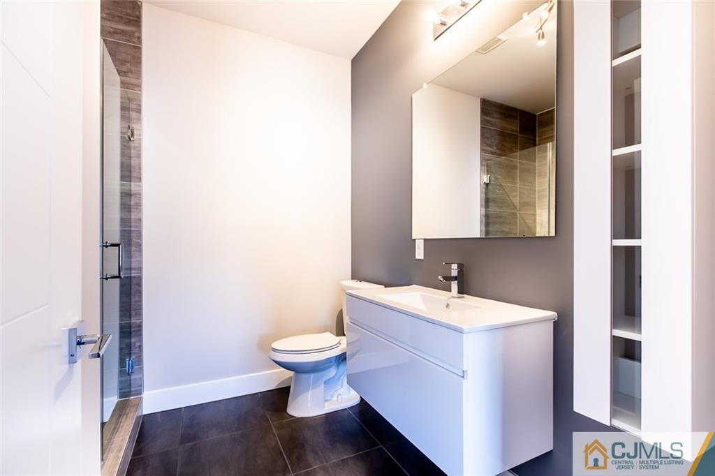 123 Millhurst Road Manalapan, NJ 07726 - Photo 23 of 27 a bathroom with a sink and a mirror