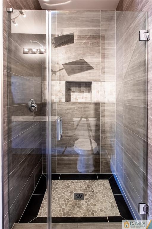 123 Millhurst Road Manalapan, NJ 07726 - Photo 24 of 27 a bathroom with a glass shower door