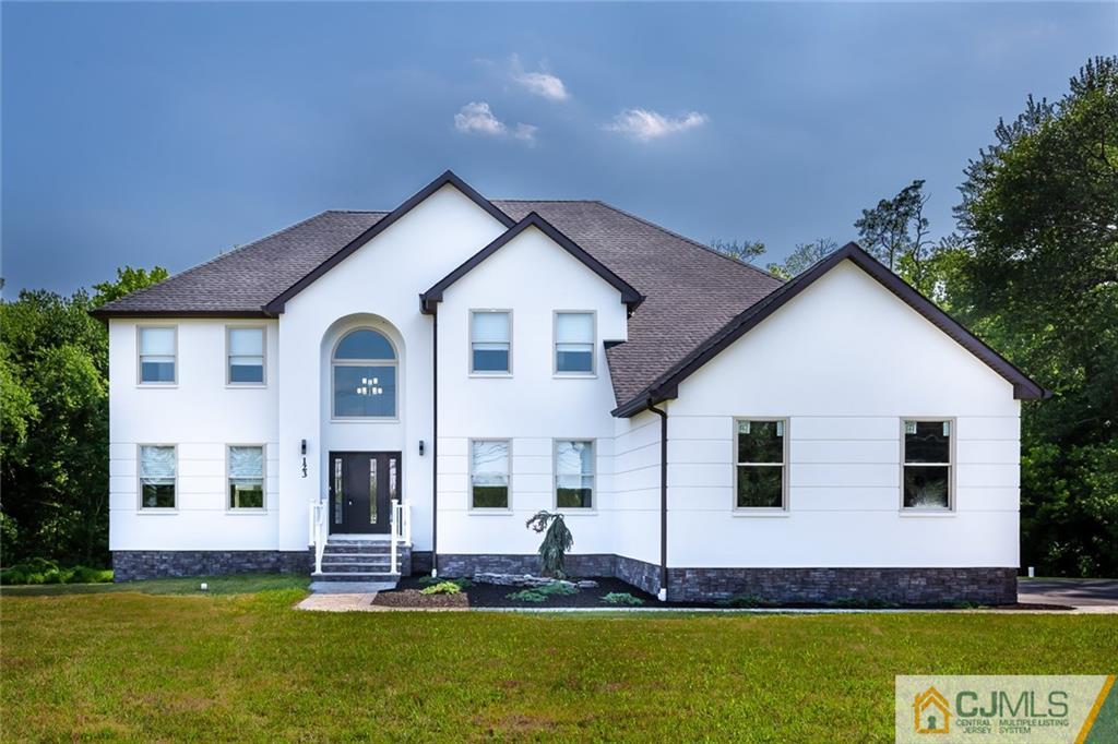 123 Millhurst Road Manalapan, NJ 07726 - Photo 25 of 27 a view of a white house with a big yard and potted plants