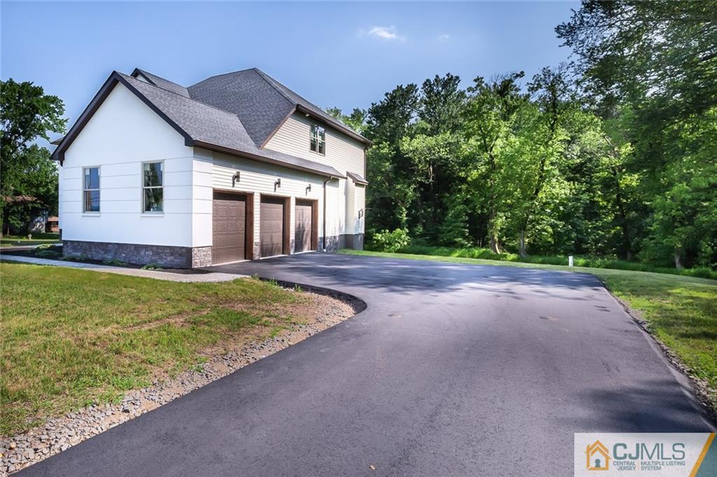 123 Millhurst Road Manalapan, NJ 07726 - Photo 26 of 27 a front view of a house with garden