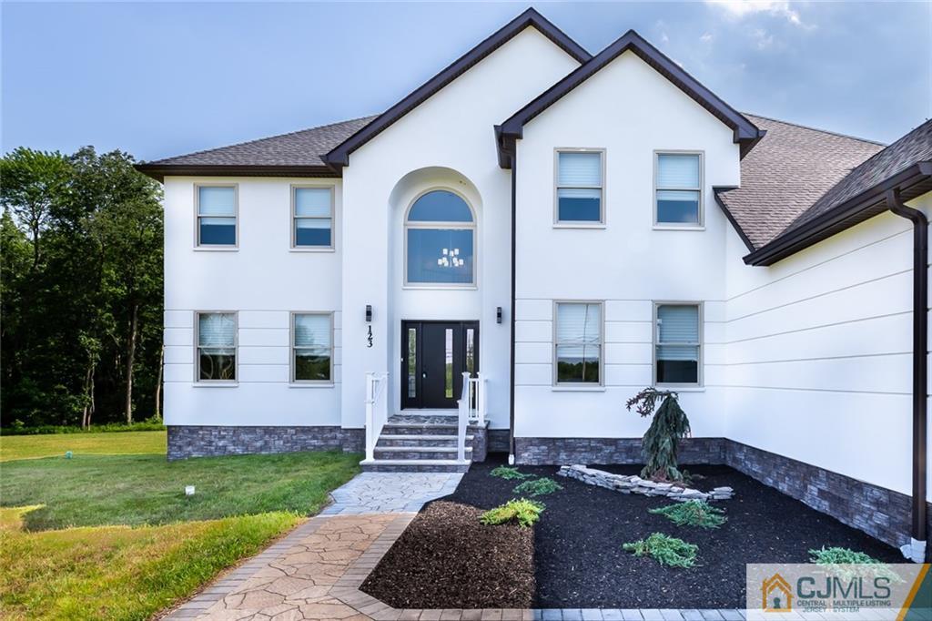 123 Millhurst Road Manalapan, NJ 07726 - Photo 27 of 27 a front view of a house with garden