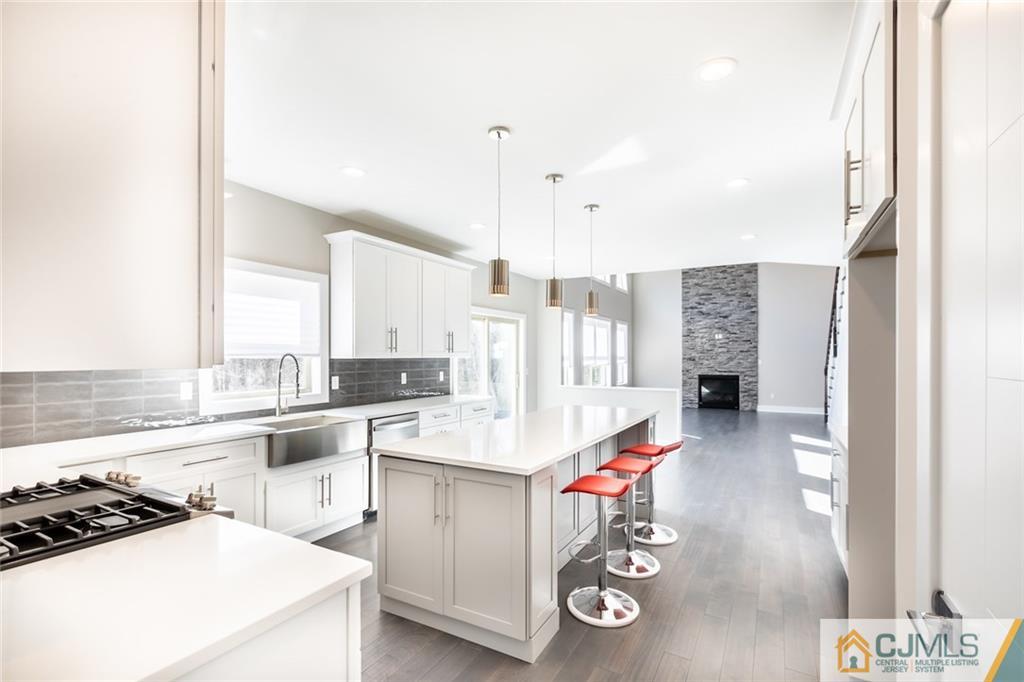 123 Millhurst Road Manalapan, NJ 07726 - Photo 5 of 27 a kitchen with a sink appliances and cabinets