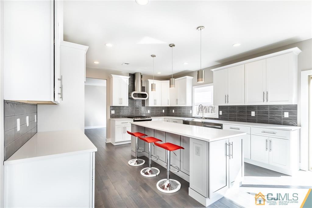 123 Millhurst Road Manalapan, NJ 07726 - Photo 7 of 27 a kitchen with a stove a sink and a refrigerator