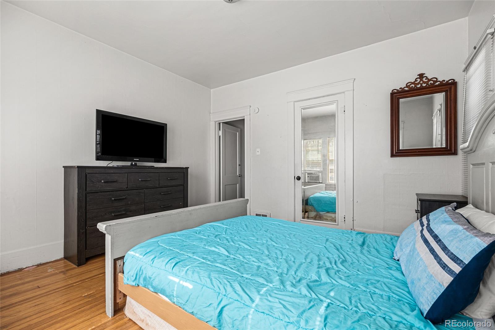 1117 16th Street Greeley, CO 80631 - Photo 15 of 37 a bedroom with a bed and a flat screen tv