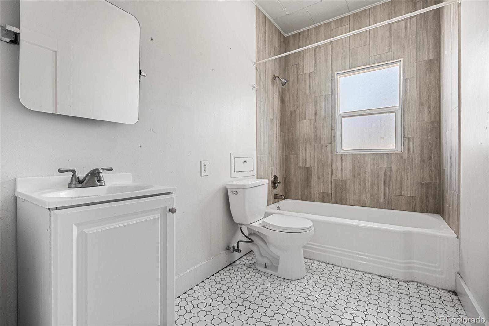 1117 16th Street Greeley, CO 80631 - Photo 19 of 37 a bathroom with a sink a toilet and shower