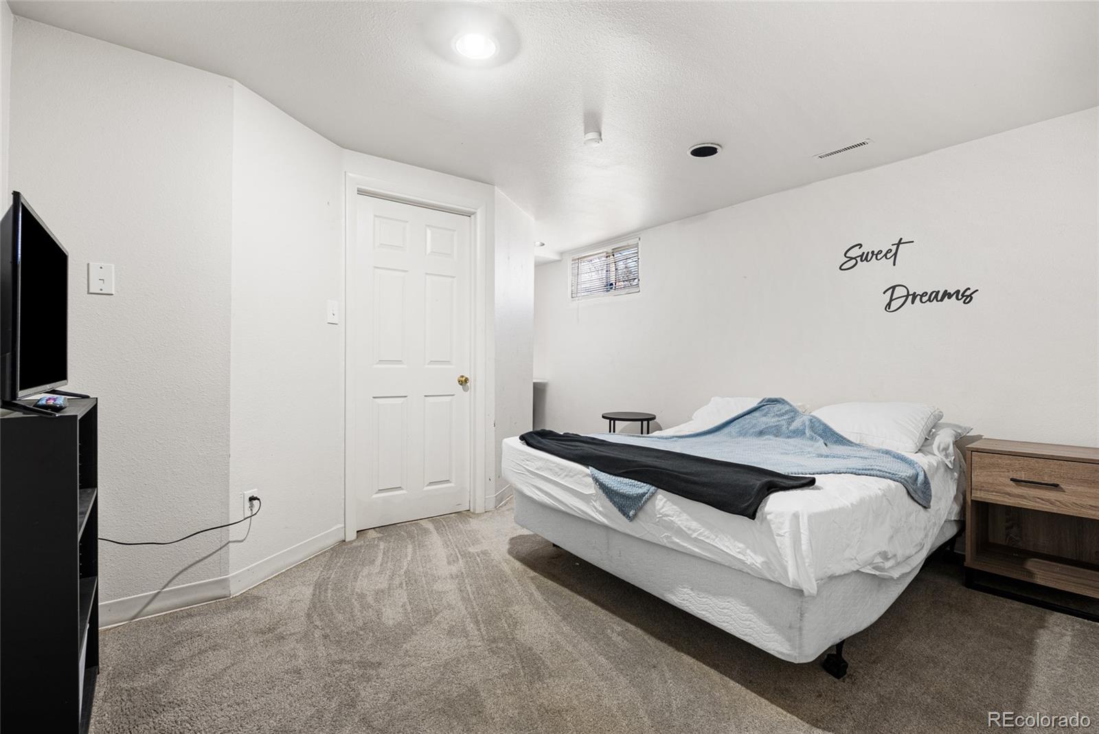 1117 16th Street Greeley, CO 80631 - Photo 26 of 37 a bed room with a bed and a tv