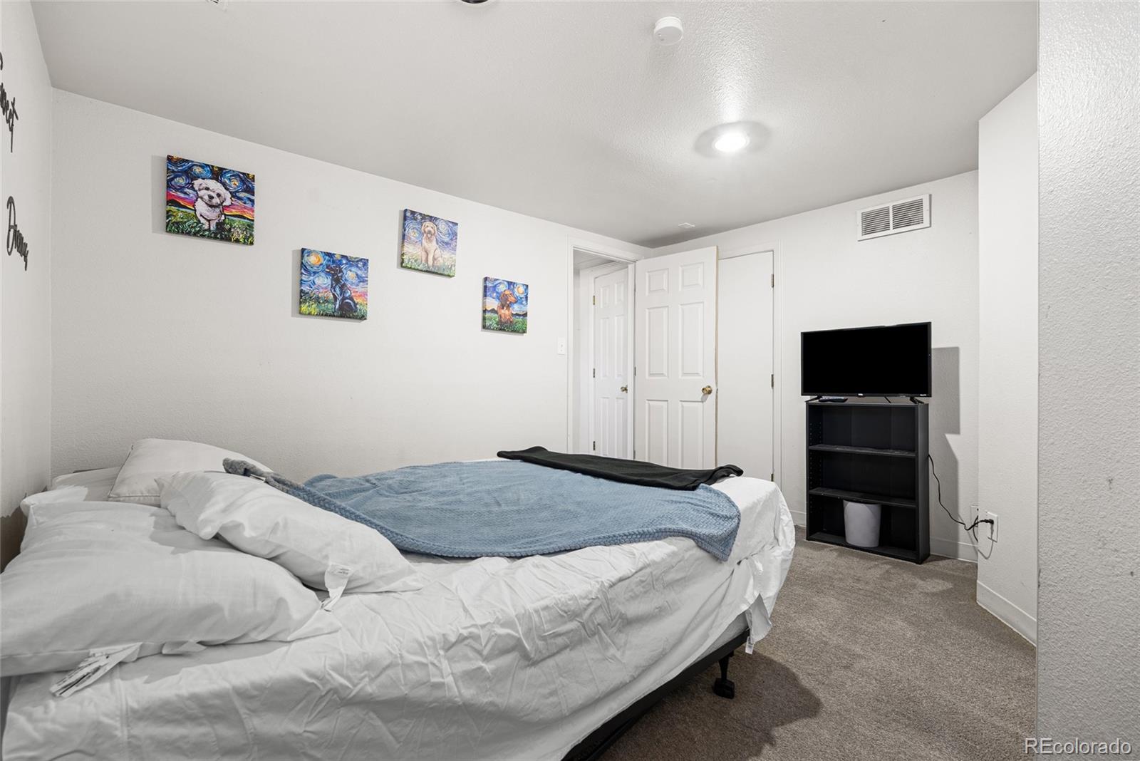 1117 16th Street Greeley, CO 80631 - Photo 27 of 37 a bedroom with a bed and a walk in closet