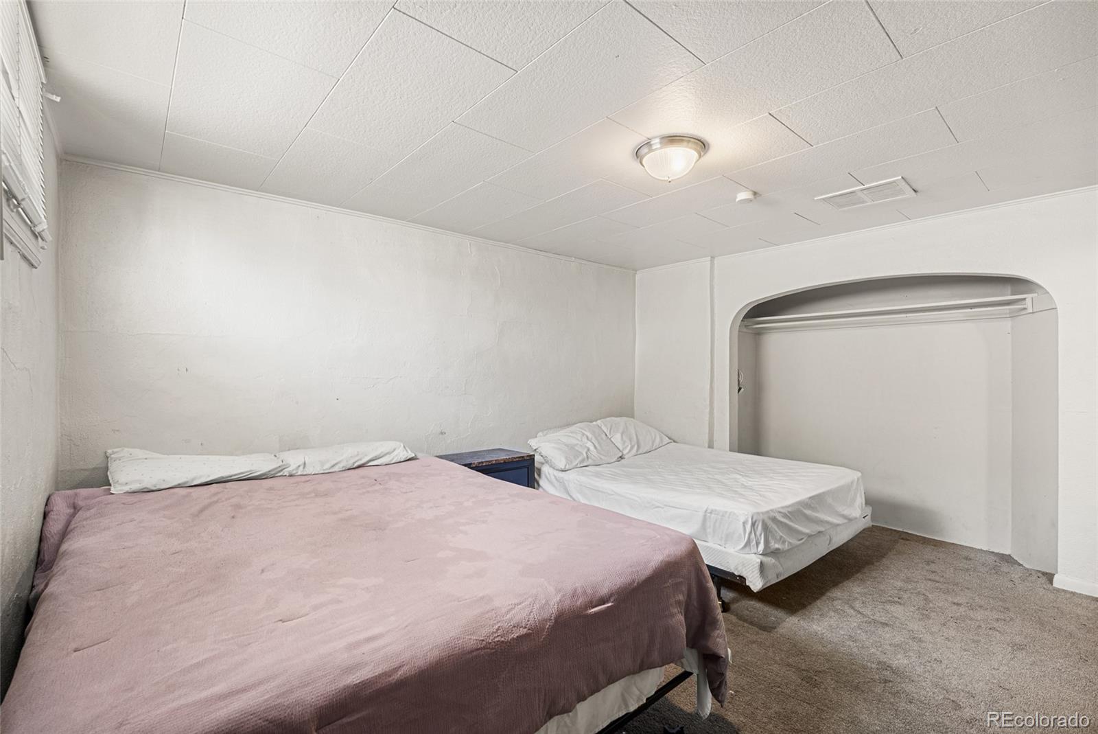 1117 16th Street Greeley, CO 80631 - Photo 28 of 37 a bedroom with two beds and a window