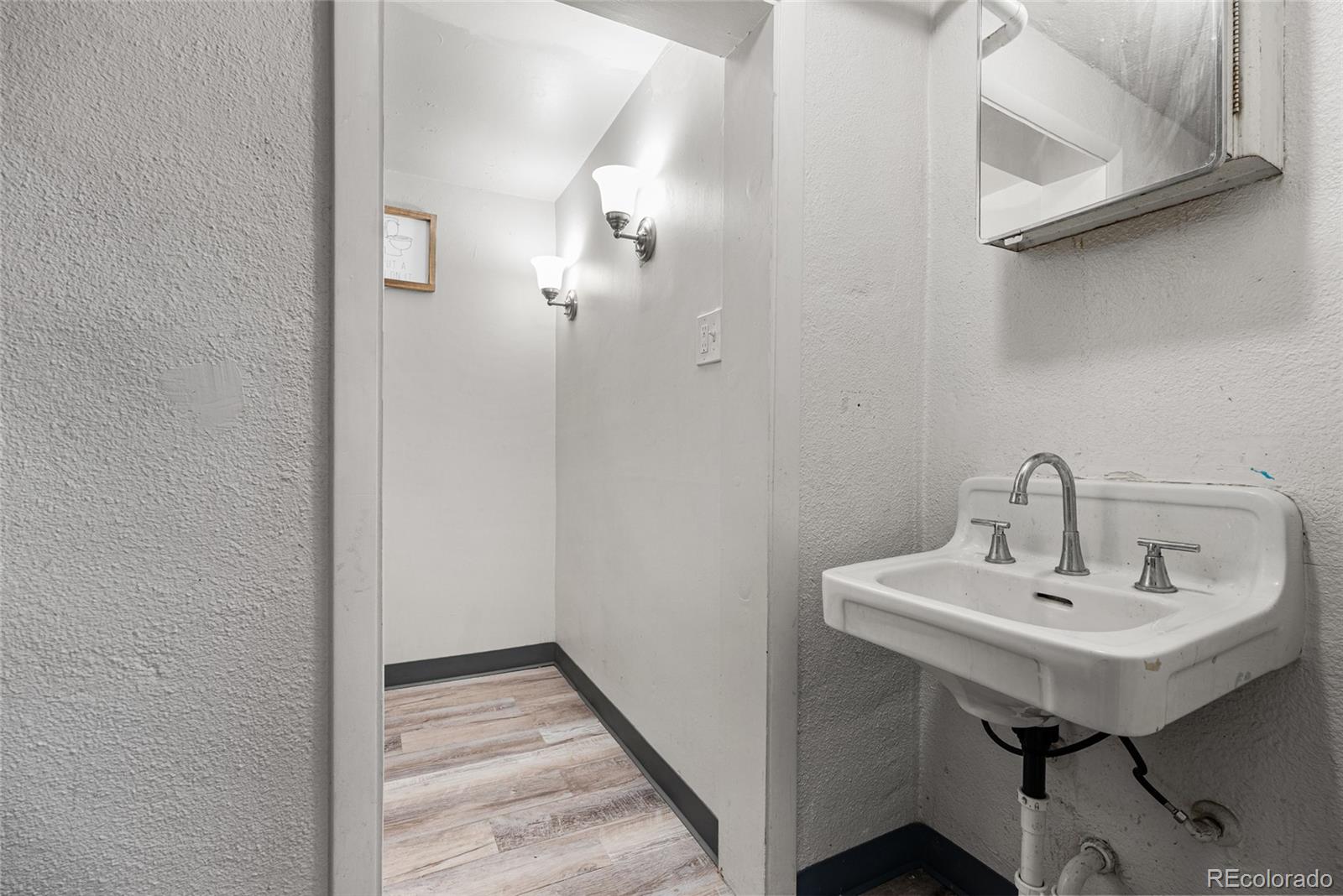 1117 16th Street Greeley, CO 80631 - Photo 30 of 37 a bathroom with a sink and a mirror