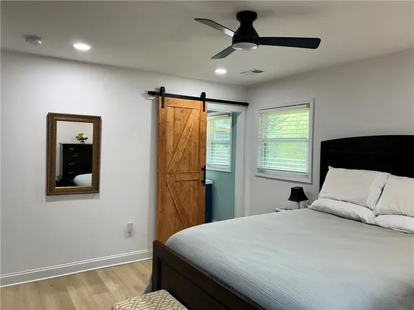 a bedroom with a bed and a television
