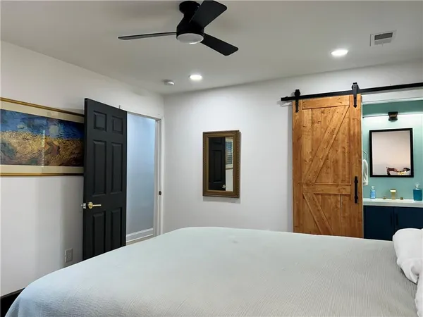 a bedroom with a bed and a chandelier