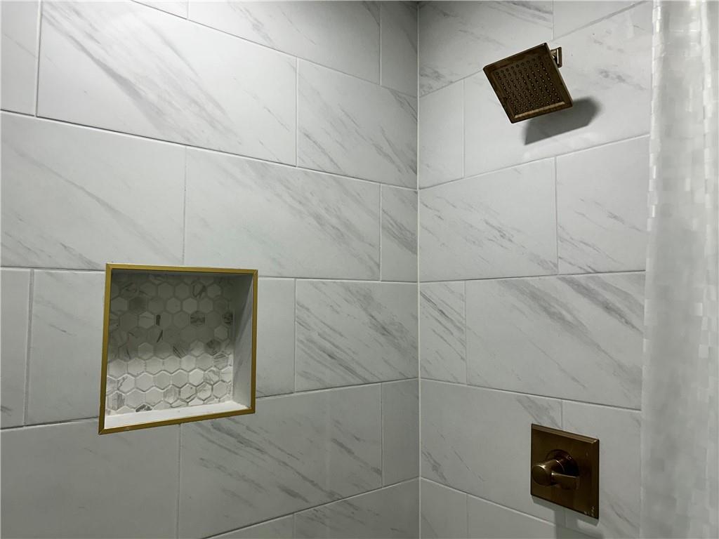 3271 Kelley Chapel Road Decatur, GA 30034 - Photo 23 of 27 a picture of a bathroom with a shower and a mirror