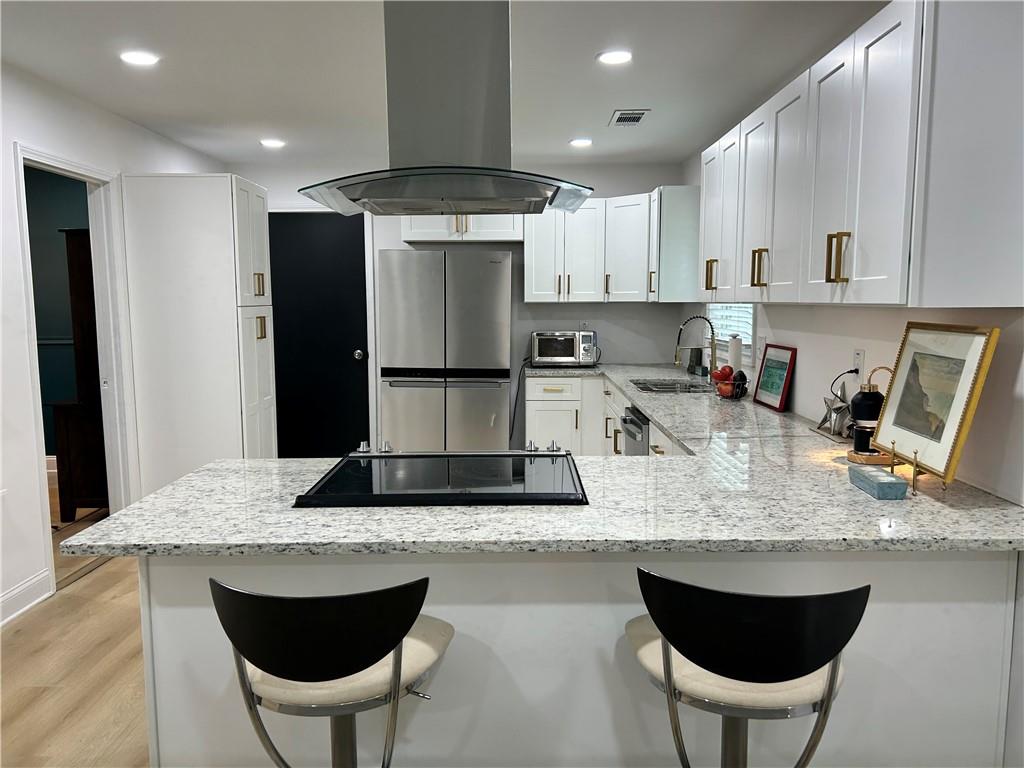 3271 Kelley Chapel Road Decatur, GA 30034 - Photo 10 of 27 a kitchen with stainless steel appliances granite countertop a kitchen island a stove a sink a dining table and chairs