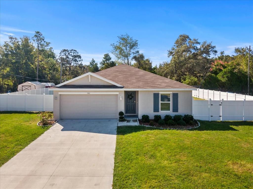 1383 Larkin Road Spring Hill, FL 34608 - Photo 1 of 1 a front view of a house with garden
