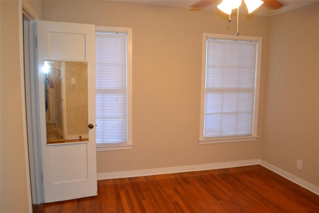 919 Denton Street Denton, TX 76201 - Photo 13 of 23 Bright bedroom with beautiful wood floors and dual windows.