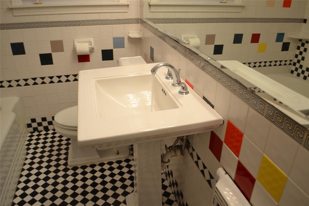 919 Denton Street Denton, TX 76201 - Photo 17 of 23 Vibrant bathroom with colorful tile accents and a large vanity.
